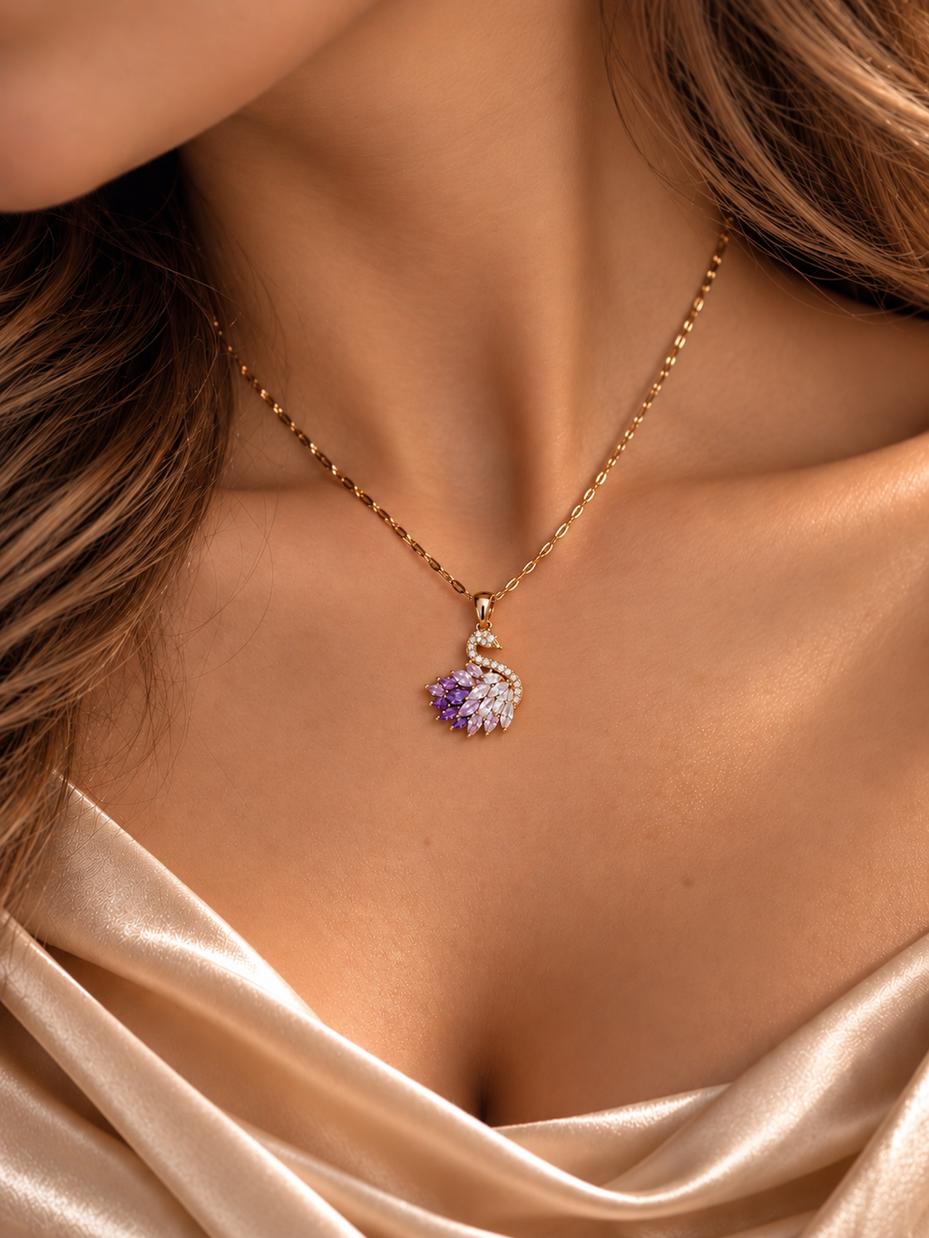 Amethystblüte Schwan-Collier am Hals getragen: goldfarbene Kette mit Schwan-Anhänger und fliederfarbenen Zirkonia zu hellem Satinkleid