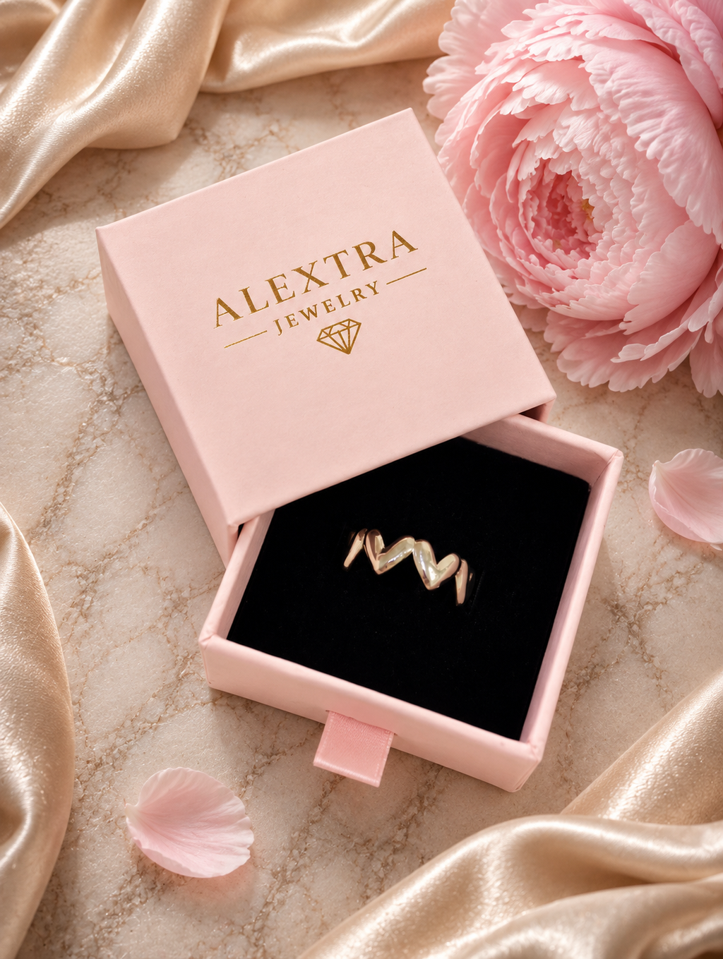 Silberfarbener Herzband Ring in einer rosa Alextra Jewelry Schmuckbox